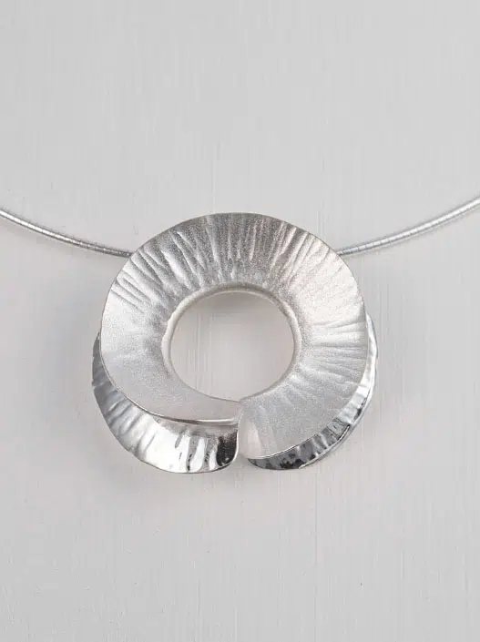 A modern hand made silver circular necklace